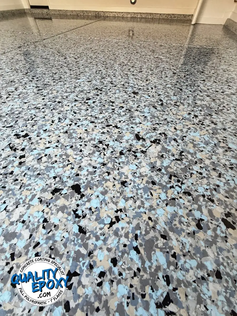 A Galaxy flake floor in deep blue, black and white, finished and glossy across a garage bay