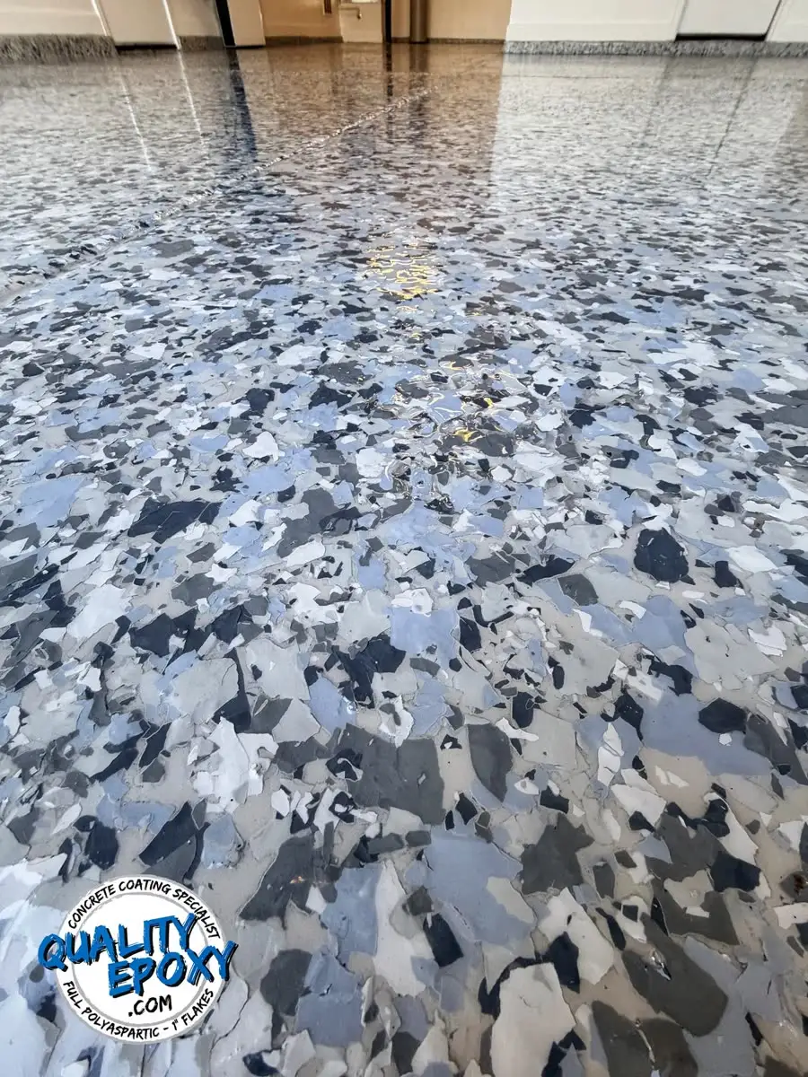 A Polar flake floor in white, ice grey and pale blue running the length of a garage