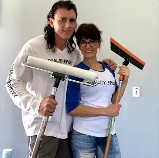 Jon and Monica Kopp in Quality Epoxy shirts, holding a roller and a squeegee